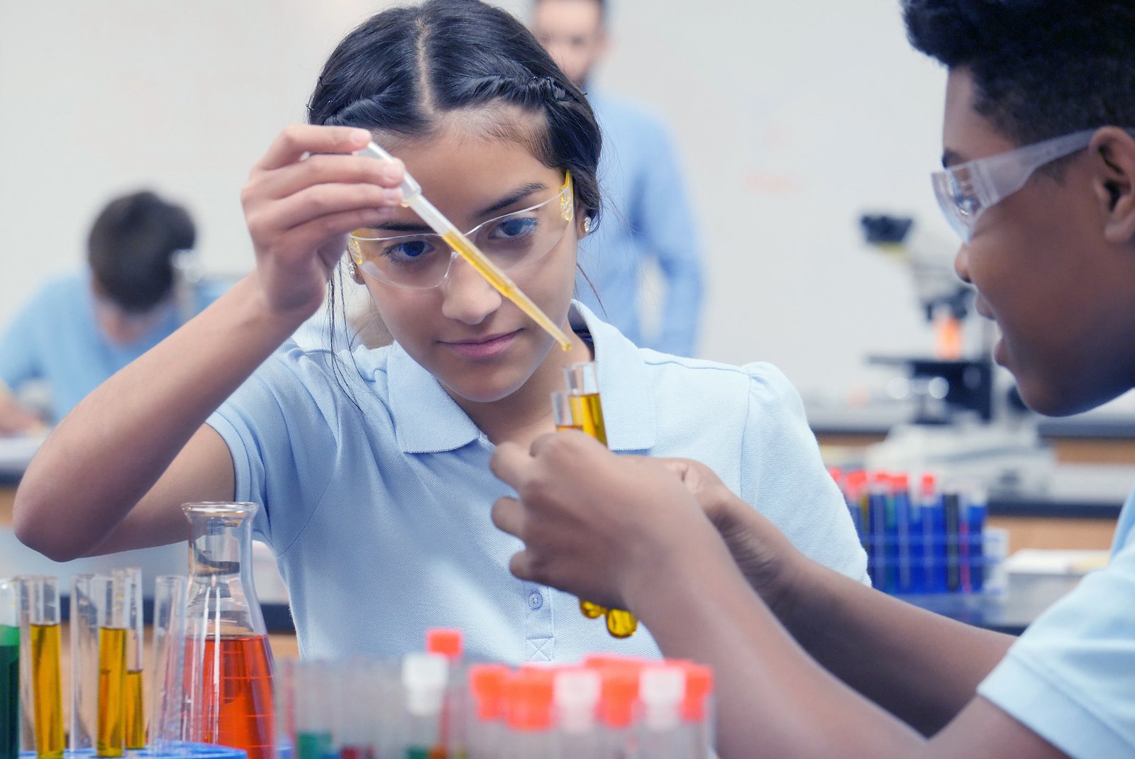 IIT-JEE girl performs chemistry experiment with lab partner